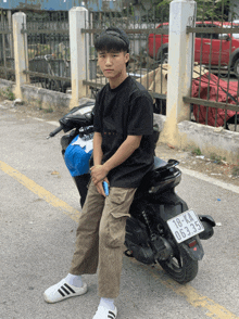 a young man sitting on a scooter with a license plate that says 18 ka 06.335