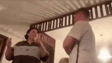 a woman is talking to a man in a living room .