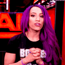 a woman with purple hair is wearing a black t-shirt that says ' smackdown ' on it