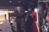 a person playing a violin in front of a sign that says candies