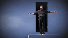 a man with his arms outstretched in front of a door