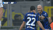 a soccer player with the number 22 on his jersey is hugging another player