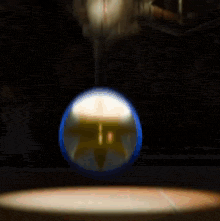 a cartoon character with a crown on his head is sitting in front of a wheel .