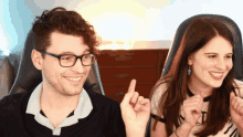 a man wearing glasses and a woman wearing a shirt that says ' n ' on it