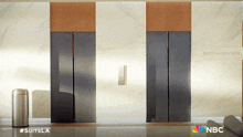 two elevators in a building that says black & associates on it