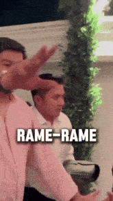 a man in a pink shirt says " rame-rame " in front of two other men