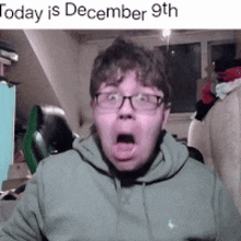 a man with glasses is making a funny face with the date december 9th