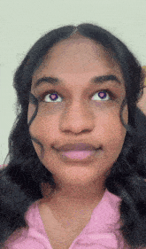 a close up of a woman 's face with purple eyes and hearts on them