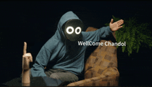 a man in a blue hoodie is sitting in a chair with the words wellcome chandol on the bottom