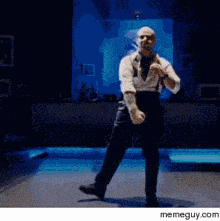 a man is dancing on a stage with a memeguy.com watermark on the bottom