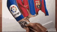 a person is drawing a soccer player with a laliga logo on their arm