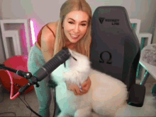 a woman is standing next to a dog in front of a secret lab gaming chair