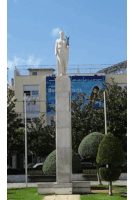 a statue of a man stands in front of a building that says bank