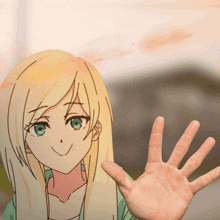 a hand is reaching out towards a drawing of a girl with blonde hair