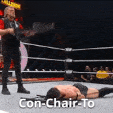a man is laying on the ground in a wrestling ring with the words con-chair-to written on the bottom