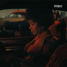 a woman sitting in the back seat of a car with a wallet that says fbi on it