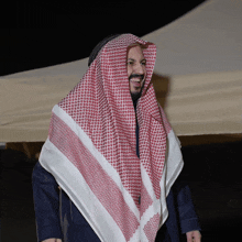 a man wearing a red and white scarf covering his head