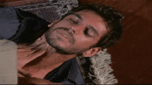 a man with a beard is laying on a rug