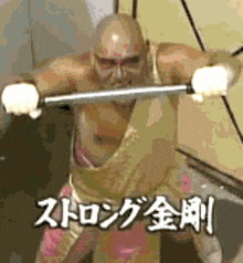 a man without a shirt is holding a barbell in his hands in a gym .