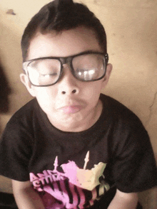 a young boy wearing glasses and a shirt that says ' ain 't it ' on it