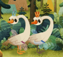 two ducks with crowns on their heads are standing in a forest