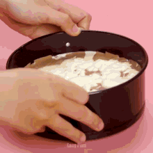 a person is making a cake in a pan that says easy plus