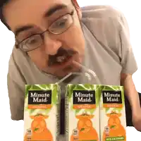 a man drinking orange juice from minute maid boxes