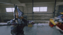 a man in a robot costume is fighting another man