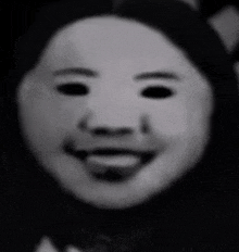 a black and white photo of a child 's face with a mask on .