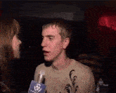 a man talking into a microphone with the words last oasis behind him