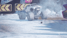 a monster truck driving down a snow covered road
