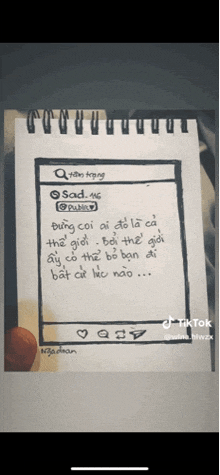 a person is holding a piece of paper that says sad