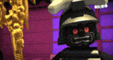 a lego character with red eyes and a skull on his head