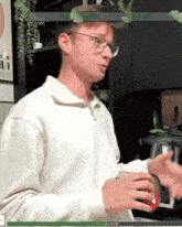 a man wearing glasses stands in front of a screen that says donation goal 33