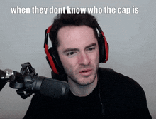 a man wearing headphones stands in front of a microphone with the caption when they do n't know who the cap is