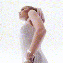 a woman wearing a watch is holding her back