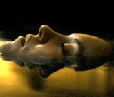 a close up of a person 's face floating in the water