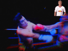 a man in a red bull shirt is boxing