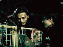 a man and a woman are standing next to each other in a dark room