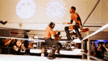 two wrestlers in a ring with a logo for apl on the wall