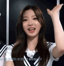 a girl in a sailor uniform holds her hand up