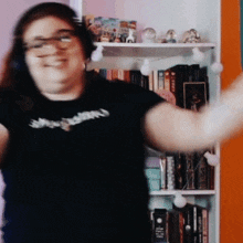 a woman wearing headphones and a black shirt that says justice