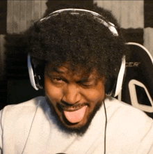 a man wearing headphones has his tongue hanging out