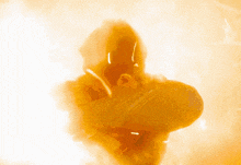 a silhouette of a person standing in a smokey area