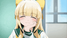 a girl with blonde hair and a yellow bow on her head smiles with her hand on her chin