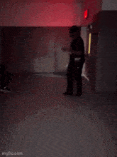a blurry picture of two people dancing in a dark room with a red light behind them