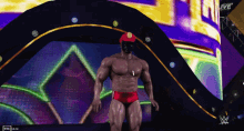 a man in a red swim suit is standing in front of a sign that says " live "