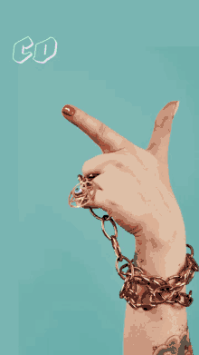 a woman 's hand with a chain around her wrist and smiley faces behind her and the words go on my bad