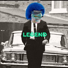 a man in a suit and tie is standing in front of a car with the word legend on it
