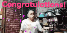 a woman is dancing in front of a sign that says congratulations !